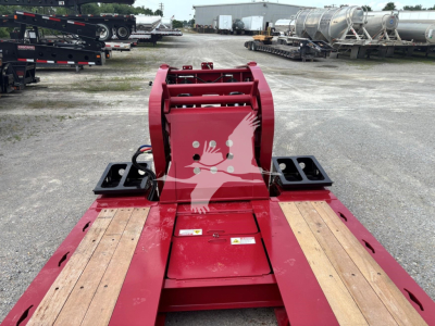 Red Fontaine 55 Lowboy trailer hitch attachment and wooden deck with black mounting brackets.