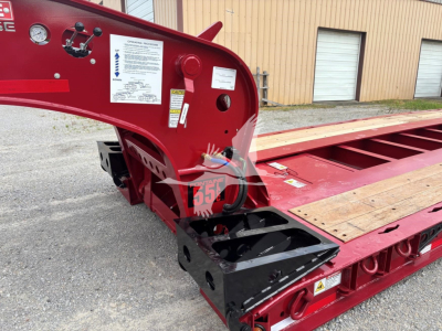 Fontaine lowboy trailer deck and neck section with warning labels and structural components visible.