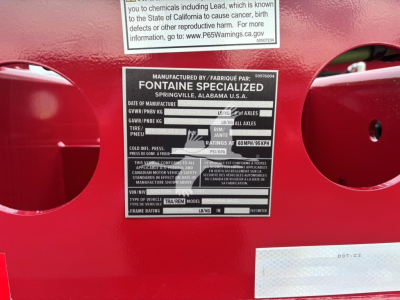 Label on Fontaine Specialized trailer showing manufactured by Fontaine Specialiezd Springville, Alabama USA. Includes GVWR, GAWR, tire size, axle ratings, and VIN plate.