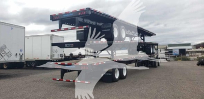 Wabash Steel Air Slider flatbed trailer in yard showing multi-axle rear and upper air slide mechanism.