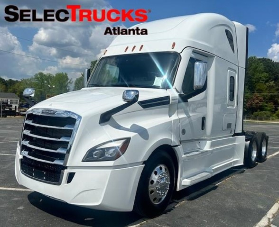 Freightliner Cascadia 126 tractor in white, side view showing cab and sleeper, SelectTrucks Atlanta logo in top left.