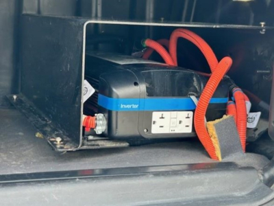 Truck battery/inverter visible in engine bay with orange cables and a blue band labeled Inverter.