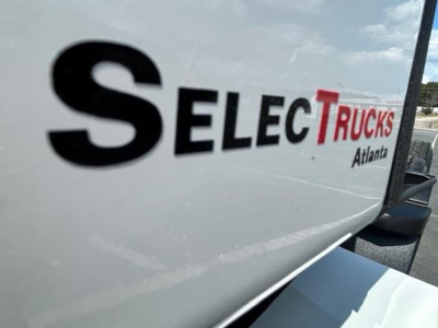 Truck side showing 'SelectTrucks Atlanta' logo on white surface.