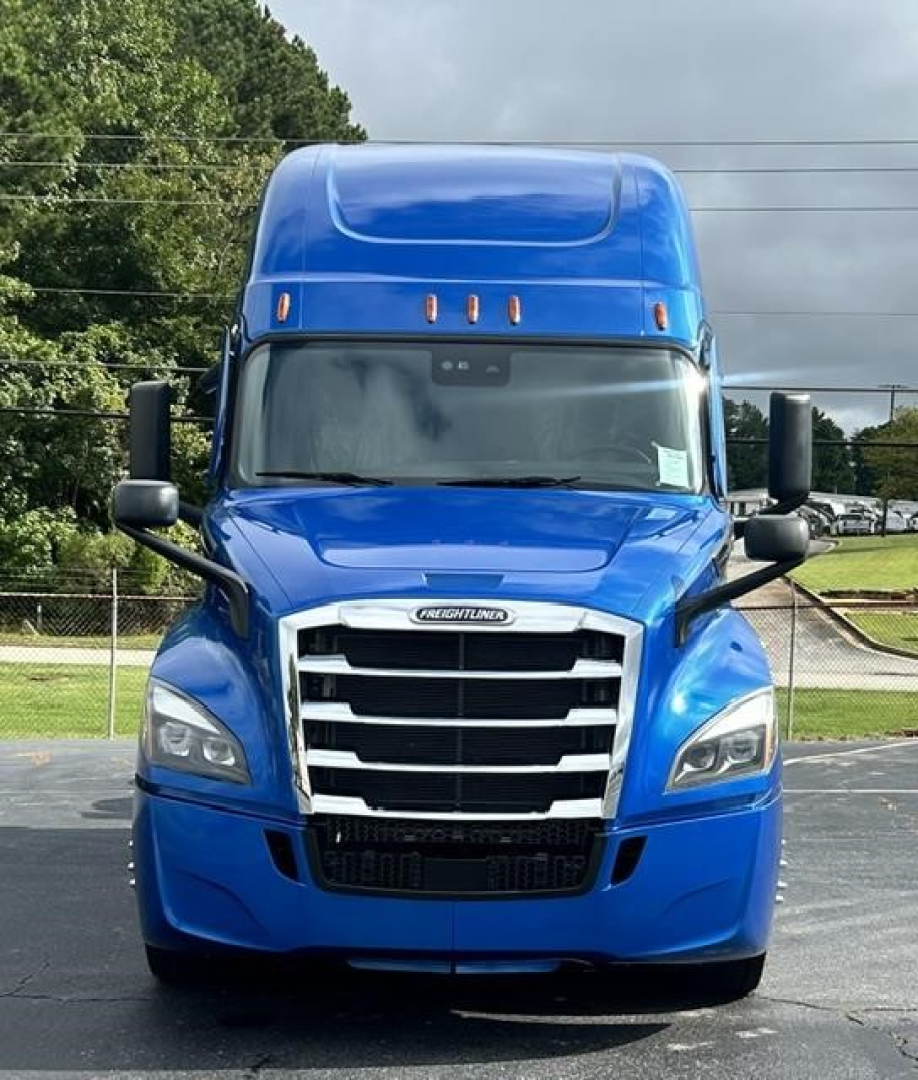 Freightliner Cascadia 126 front view showing bold chrome grille, blue cab, and sleeper top.
