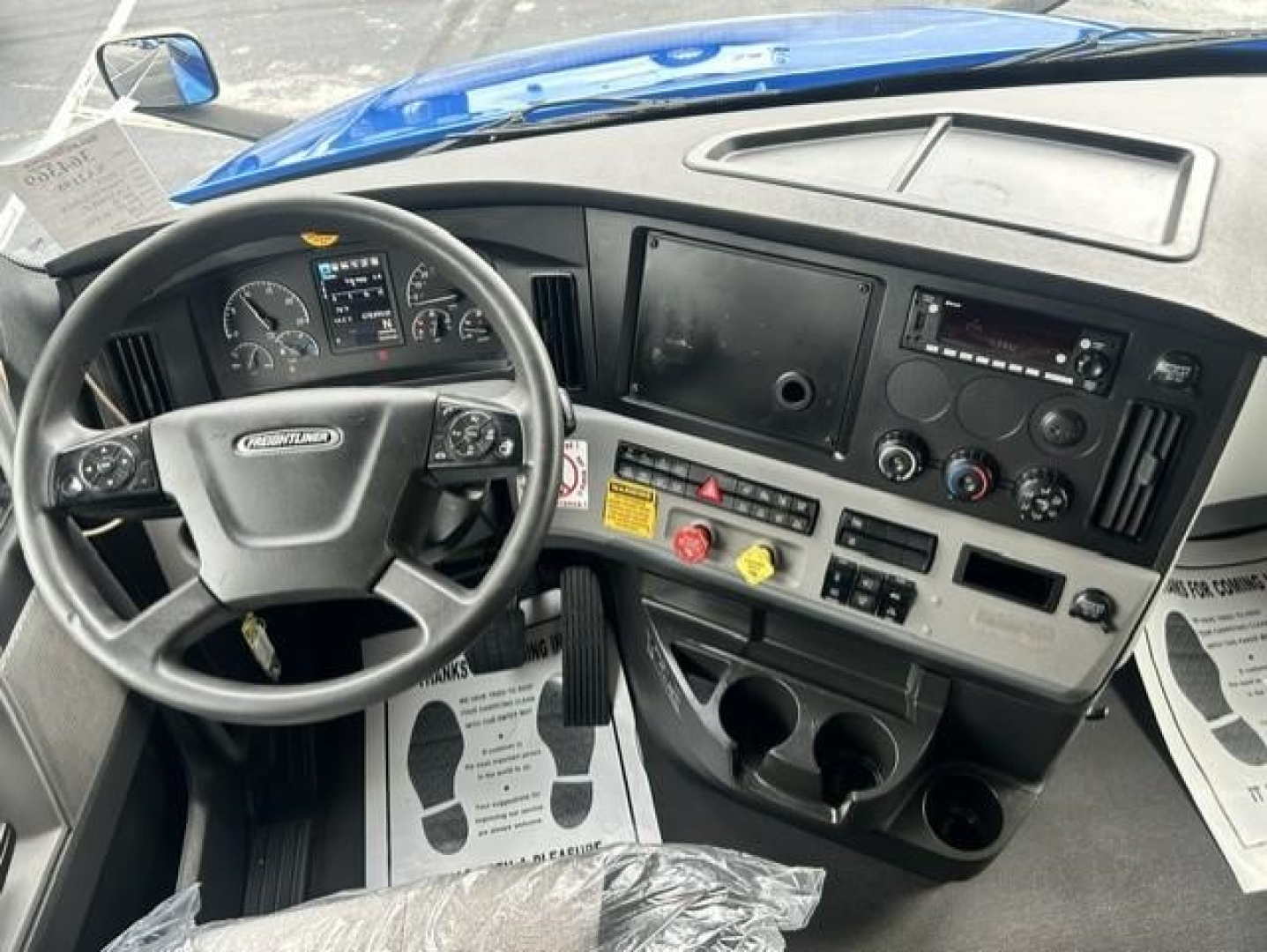 Freightliner Cascadia 126 truck interior showing dashboard with steering wheel and controls.