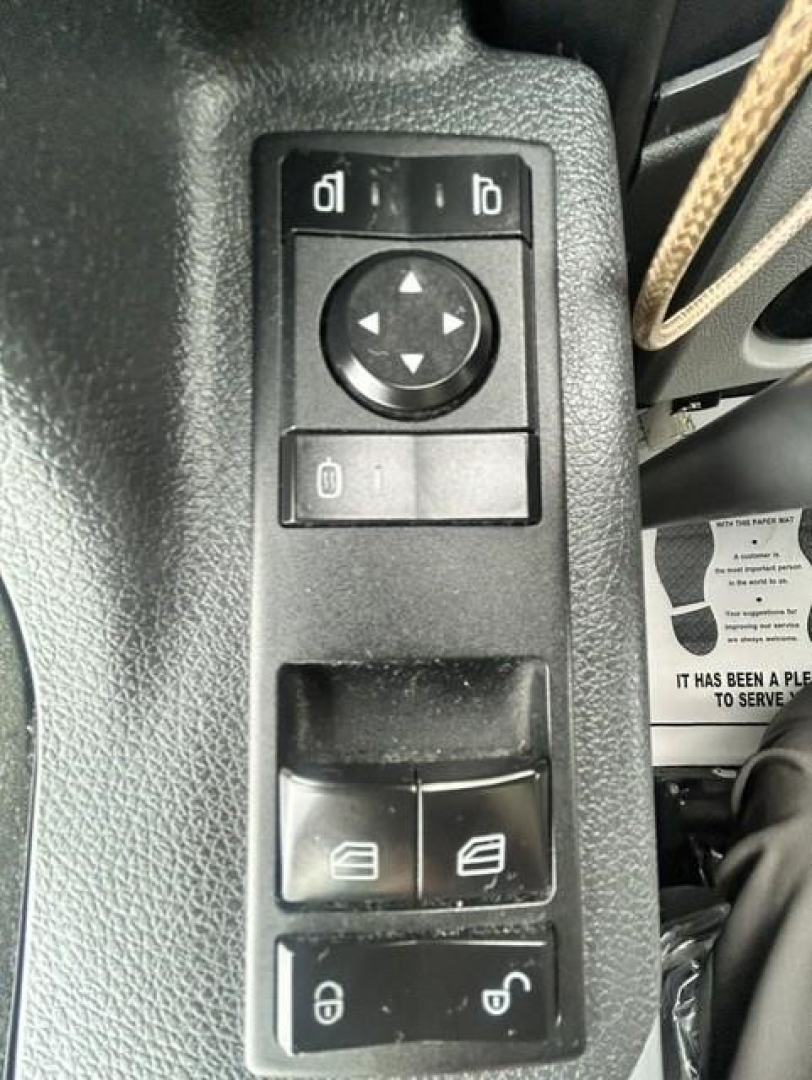 Trucks interior panel with window/lock controls and mirror adjustment joystick in Freightliner Cascadia cabin.