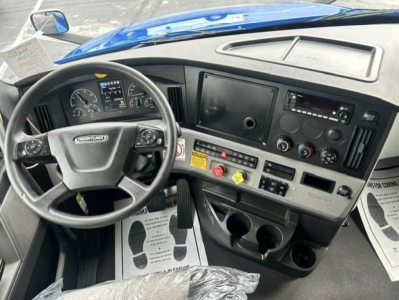 Freightliner Cascadia 126 truck interior showing dashboard with steering wheel and controls.