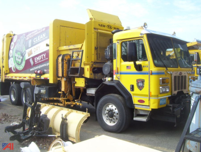 Peterbilt PB320 New Way side loader refuse truck showing cab and side loader body with yellow color