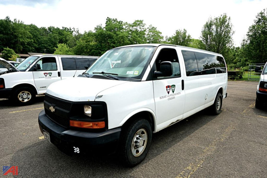 Chevrolet Express 3500 passenger van in white, side view showing 'Express' badge and 38 on front bumper.