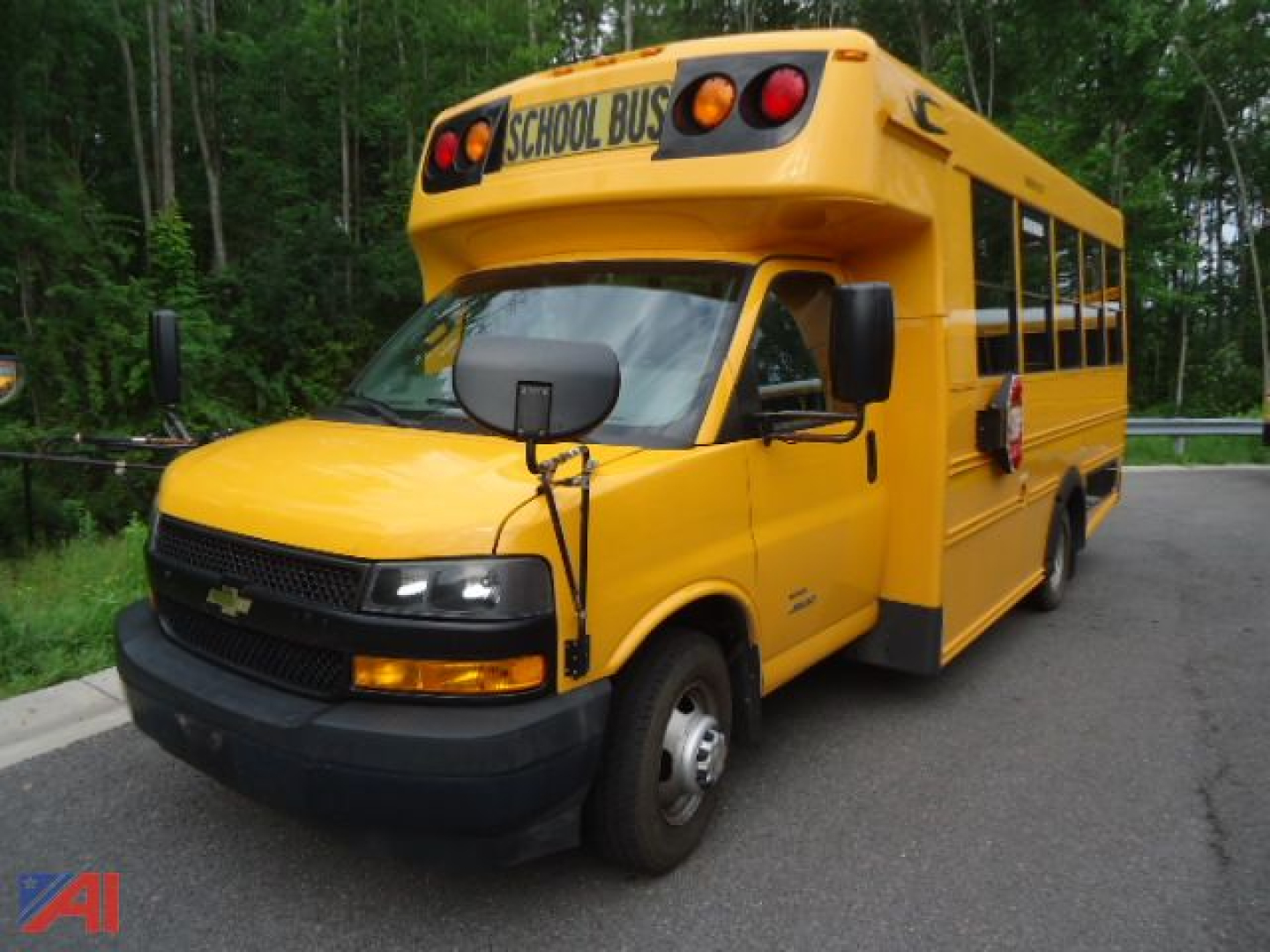 Chevrolet Express 4500 school bus with wheelchair accessibility features, yellow body, black front bumper, and 'SCHOOL BUS' sign on top.