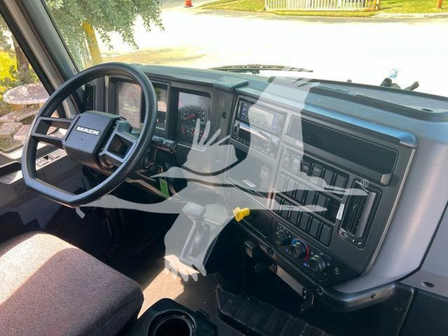 Mack MD6 interior cab dash and steering wheel with dashboard controls visible; no legible text highlighted.