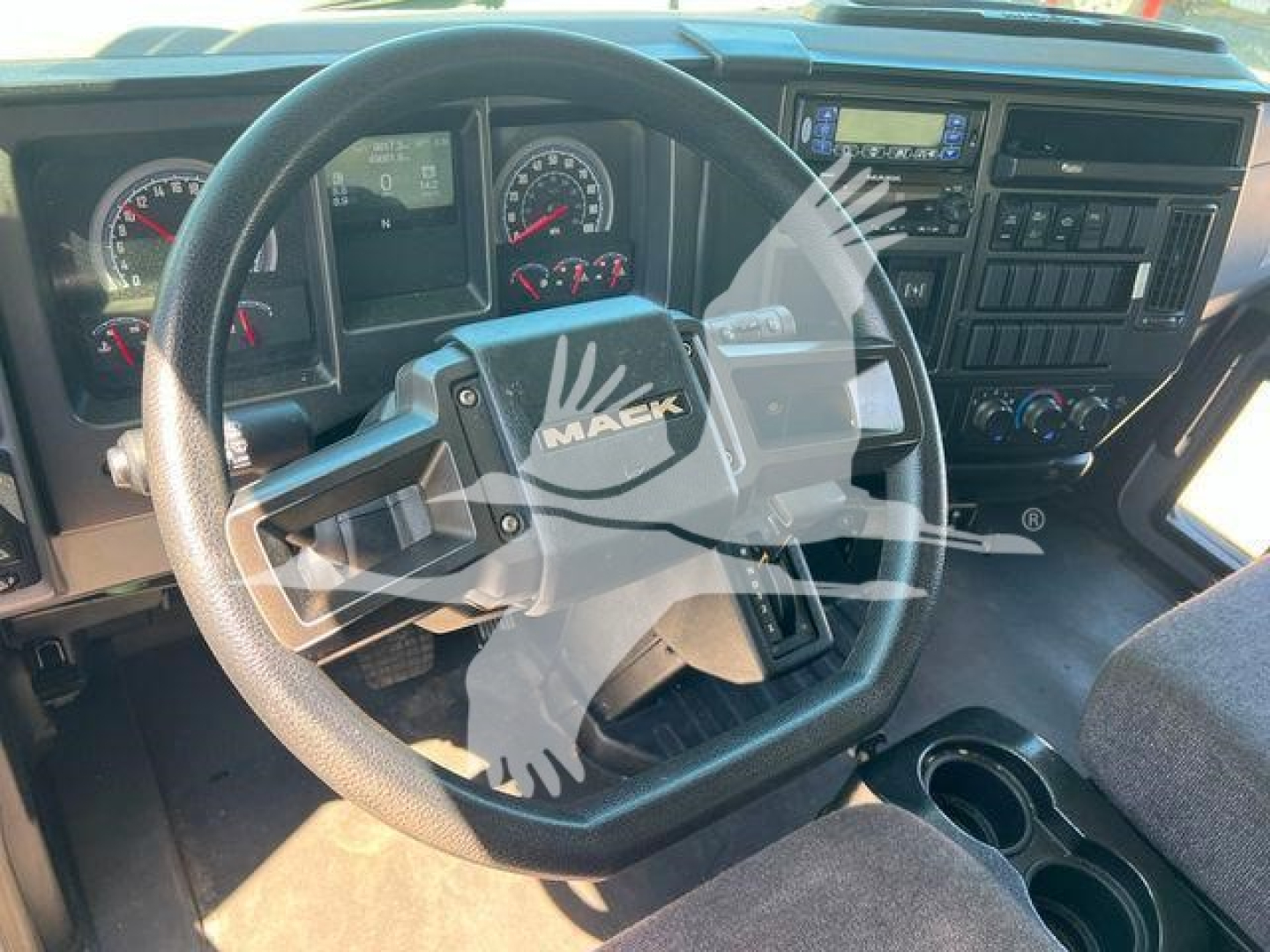 Mack MD6 interior showing steering wheel with MAEK emblem and dashboard gauges, overhead controls, and center console.
