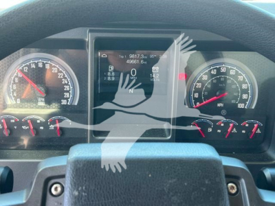 MD6 dash cluster with digital display center showing vehicle data and gauges on left and right. Center screen displays numbers and icons, steering wheel at bottom with control stalks.