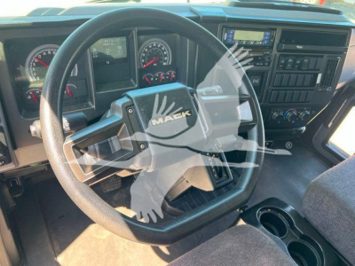 Mack MD6 interior showing steering wheel with MAEK emblem and dashboard gauges, overhead controls, and center console.
