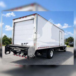 Rear and side view of a white refrigerated Mack MD6 box truck showing rear doors, reflective tape, and dual rear tires.