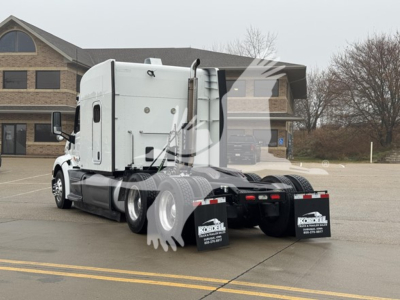 Peterbilt 579 tractor in a lot, rear view showing chassis, dual rear axles, and mud flaps with Kordell trucks branding.