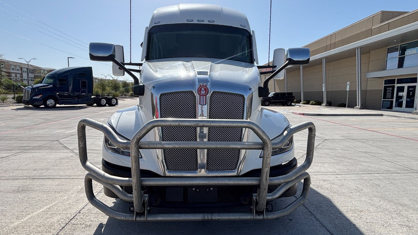 Kenworth T680 front view showing grille, bumper guard, and large mirrors.