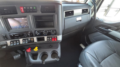 Kenworth T680 cab interior showing dashboard control panel and steering area.