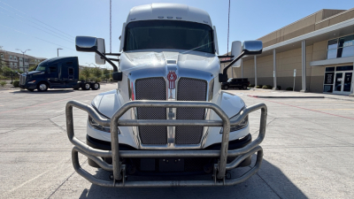 Kenworth T680 front view showing grille, bumper guard, and large mirrors.