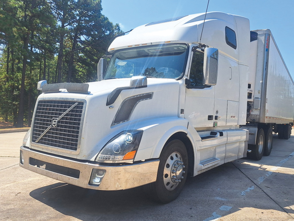 Volvo VNL 670 conventional sleeper tractor front-left view showing chrome grille and white cab.