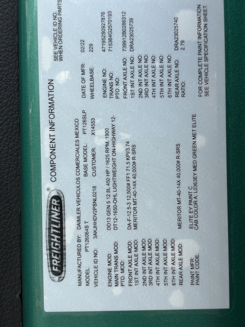 Freightliner component information label with vehicle details. Includes Manufacturer: Daimler Truks? (Freightliner) and model, engine, axle, frame data, and paint information in a vertical orientation.