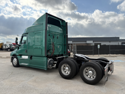 Freightliner Cascadia 126 tractor in green, side view showing sleeper cab and tandem axles.