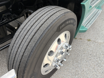 Truck wheel and dual rear tires of a Freightliner Cascadia 126 in-service showing 275/80R22.5 tire and polished dual wheel hub with lug nuts.