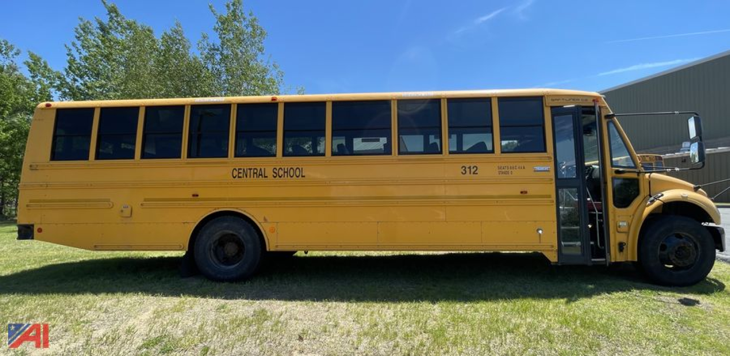 School bus side view showing Central School 312 lettering on yellow Freightliner C2 bus with open door