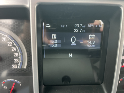 Dashboard display of a 2026 Mack MD6 showing Trip 1 data, 23.7 miles, 85°F, 4:14 time, 0 MPH, 14.3 volts, gear N, and two fuel/engine readings.