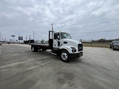 Flatbed tow truck likely a Mack MD6 with a white cab and extended black flatbed, dual rear axles, side steps, and chrome bumper.