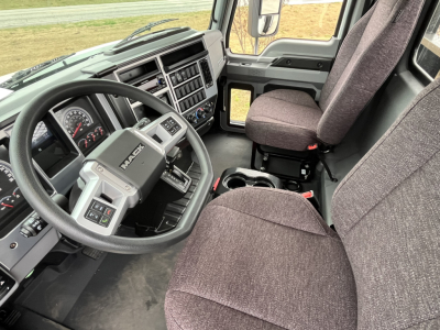 Interior view of a 2026 Mack MD6 truck cab showing steering wheel, dashboard, and front seats.