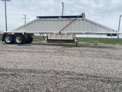 Trailer side view of a white Armor Lite SBD40 dump trailer with a double-axle rear, showing the long flatbed undercarriage and branding 'Armor Lite' near the front.