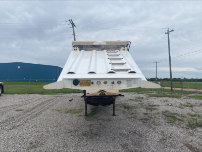 Dump trailer rear with Armor Lite SBD40 skeleton; view shows top ribbed bed, rear bumper, and safety decals
