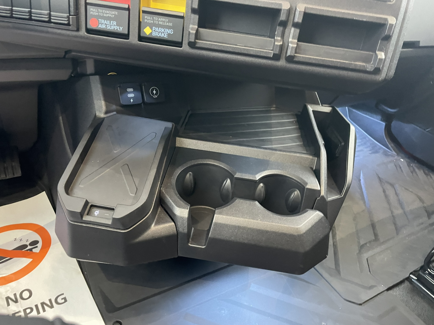 Mack PR64T76H interior center console with cup holders and storage compartments shown.
