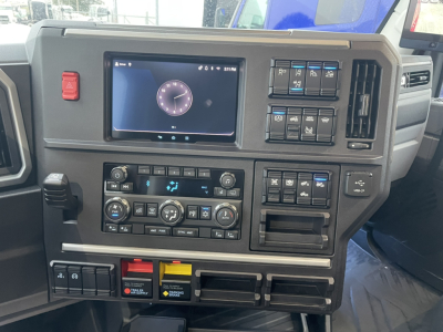 Mack PR64T76H dash and instrument cluster showing touchscreen display and control panels in center; various switches and climate controls.