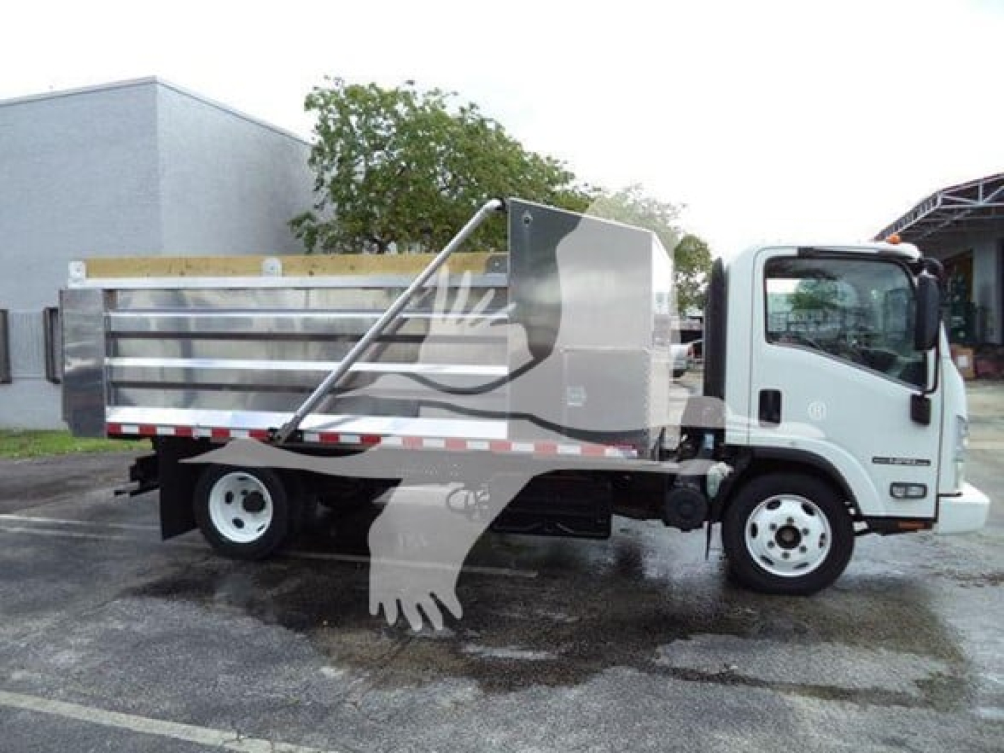 Isuzu NPR XD truck with flatbed/ dump bed showing side profile and cab view