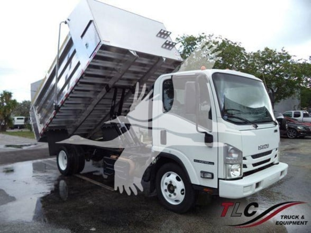 Isuzu NPR XD dump truck with tilted bed, white cab, front view showing side of dump bed raised.