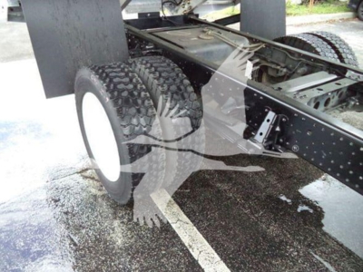 Isuzu NPR XD truck chassis showing dual rear tires and undercarriage components.