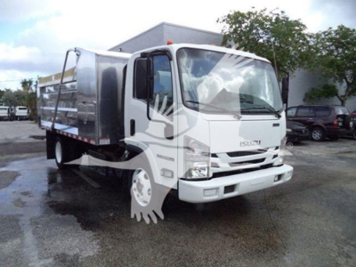 Isuzu NPR XD medium-duty truck with dump bed, front view, in-service signage and chrome grille