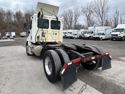Truck chassis rear view showing fifth wheel and mud flaps for a Freightliner Cascadia113.