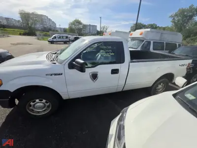 Ford F-150 pickup truck in white, side view with extended cab, showroom decals on door, VIN visible on windshield, 4x4 badge on rear, utility bed in a parking lot.