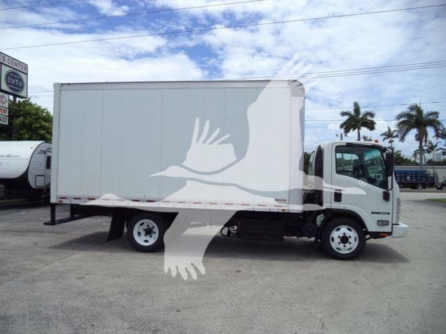 Isuzu NRR box truck side view showing cargo box and cab with white body.