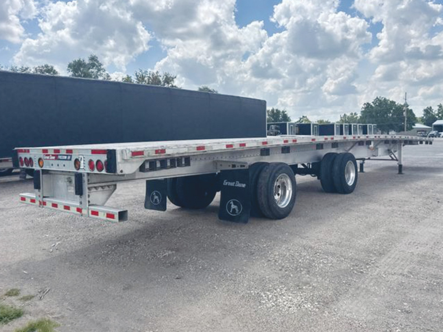 Great Dane Freedom XP flatbed trailer side and rear view showing dual rear axles and aluminum deck.