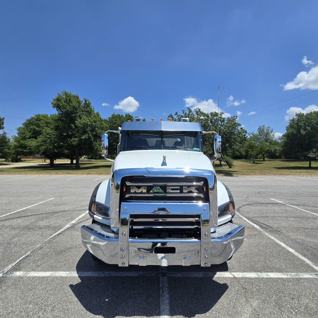 Mack GR64B mixer truck front view showing chrome grille with MACK letters and bumper.