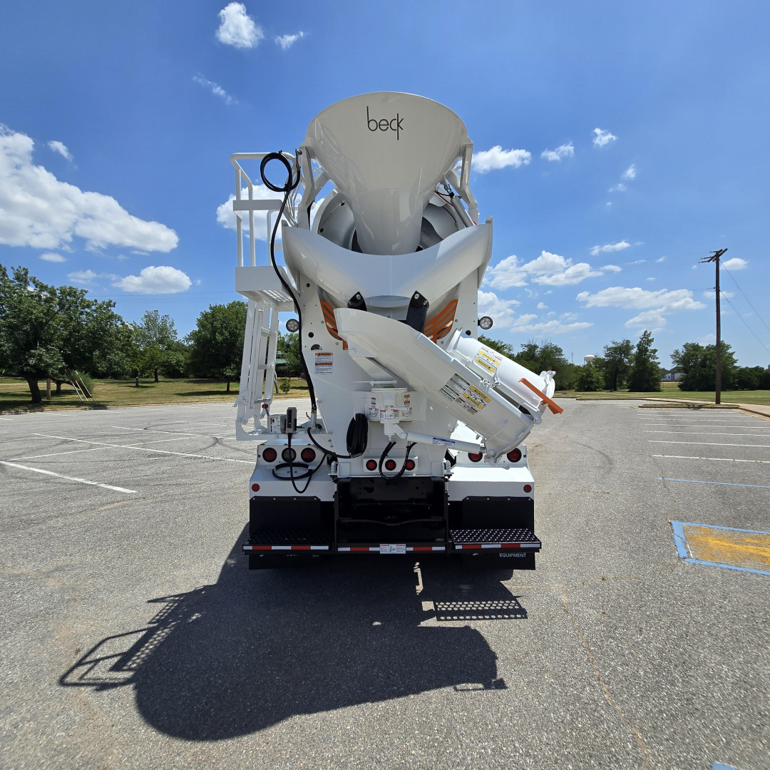 Mack GR64B mixer truck rear view showing hopper and chute assembly with Beck branding visible.