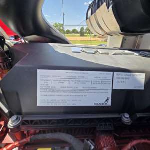 Mack GR64B engine bay label showing immediate engine information and serial details.