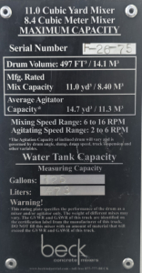Mack mixer identification plate showing 11.0 Cubic Yard Mixer, 8.4 Cubic Meter Mixer, Serial Number F-?  - Part of mixer body with capacity details, drum volume 497 ft³ / 14.1 m³, mix capacity 11.0 yd³ / 8.40 m³, average agitator capaci