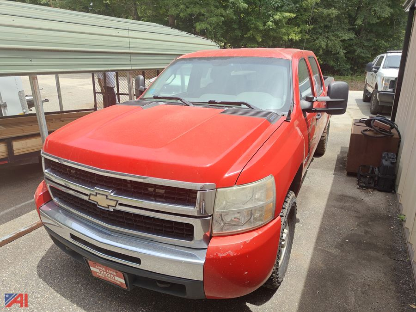 Red 2008 Chevrolet Silverado 1500 pickup truck at a used lot, front three-quarter view with chrome grille and Chevrolet emblem