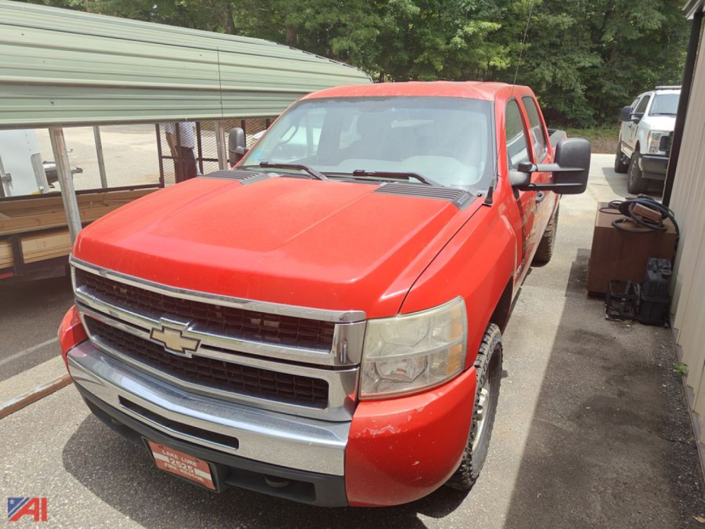 Red 2008 Chevrolet Silverado 1500 pickup truck at a used lot, front three-quarter view with chrome grille and Chevrolet emblem
