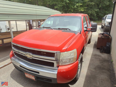 Red 2008 Chevrolet Silverado 1500 pickup truck at a used lot, front three-quarter view with chrome grille and Chevrolet emblem